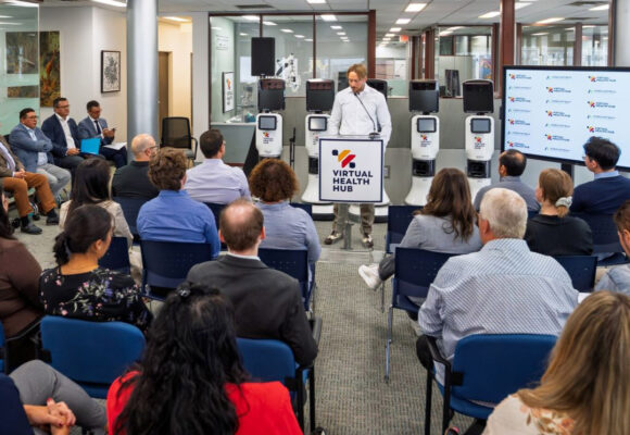 VHH Director of Digital Health Projects speaks to a gathered audience at the VHH main office.