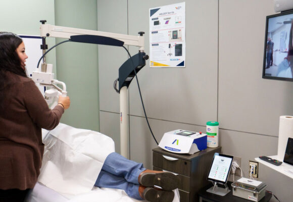 Remote Presence Nurse Clinician Brittany Olson guides the MELODY robotic ultrasonography system to examine a patient during a live technology demonstration.